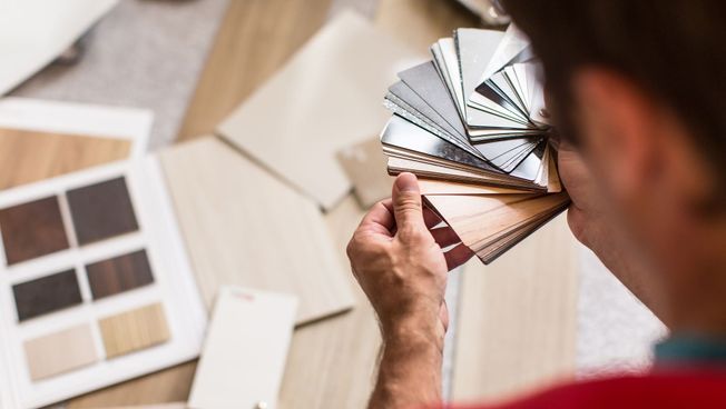 man looking at vinyl flooring